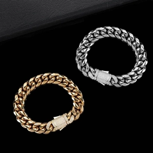 Close-up of gold and silver Cuban chain bracelets with iced-out square spring clasps