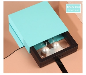 Detail of teal PE film floating jewelry box drawer showing high transparency for earrings