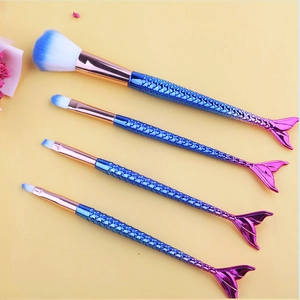 Detail of four gradient mermaid makeup brushes with blue and white soft synthetic bristles