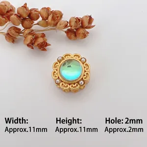 Macro detail of 11mm vintage gold spacer bead with cat eye stone and mini pearls
