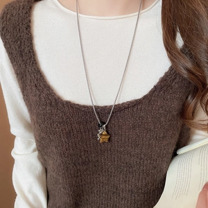 Detail of star-shaped tiger eye stone pendant on stainless steel beaded necklace