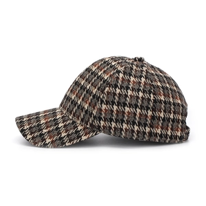Close-up of thick wool houndstooth fabric and classic six-panel design on baseball cap
