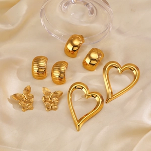 Golden C-shaped stainless steel heart and butterfly stud earring set on champagne silk
