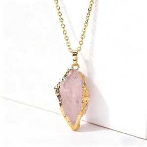 Raw pink crystal pendant with gold-plated edges on a minimalist gold chain for women