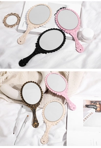 Close-up of vintage handheld mirrors with ornate floral patterns in various elegant colors