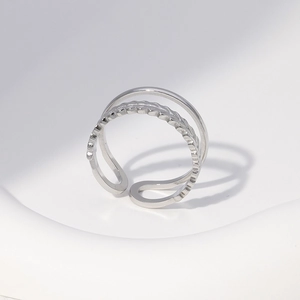 Detailed view of silver stainless steel leaf ring with wave texture and layered design