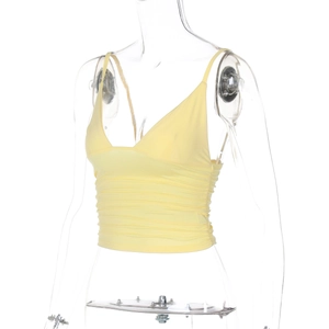 Detailed close-up of yellow V-neck camisole featuring stylish ruched fabric texture