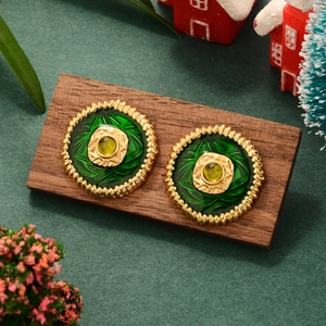Vintage gold flower earrings with green enamel and emerald gemstone in Christmas setting