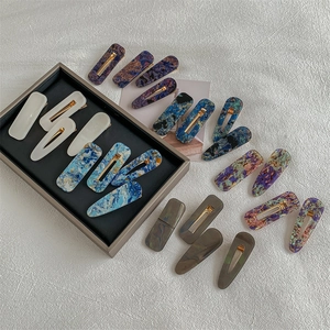 Vintage acrylic hair clip set featuring marble and floral patterns on metal duckbill clips