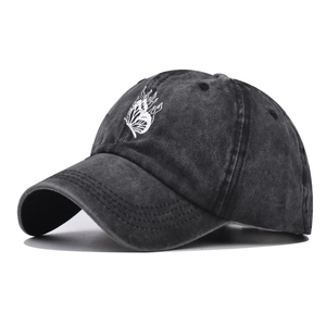 Detail of butterfly flame embroidery on a vintage washed black cotton baseball cap