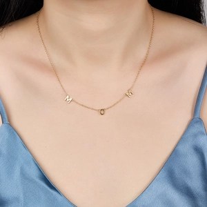 Polished gold S925 sterling silver MOM letter pendant necklace for women shown on a model