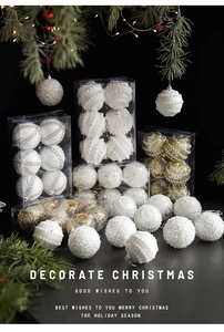 Close-up of assorted white and gold Christmas balls with glitter and sequin textures