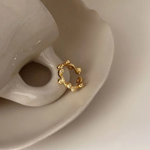 Minimalist 925 sterling silver beaded open ring in gold finish on a ceramic cup