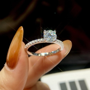 Detailed macro view of a pink moissanite ring featuring a classic six-prong setting on silver