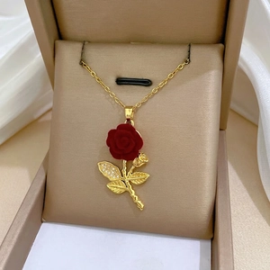 Luxurious titanium steel rose pendant necklace with diamonds on champagne satin jewelry box