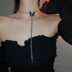 Close-up of elegant black butterfly choker with shimmering rhinestones and silver tassels