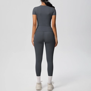 Back view of charcoal grey high-waist fitness set showing sculpting yoga leggings and slim tee