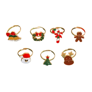 Detail of Christmas ring set featuring Santa, reindeer and tree with colorful enamel finish