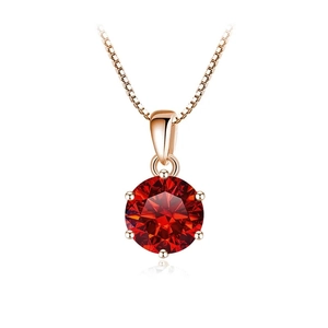 Detail of a 1 carat round red stone pendant in a six-prong rose gold setting