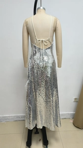 Detail of silver sequined dress featuring backless design and crisscross straps on mannequin