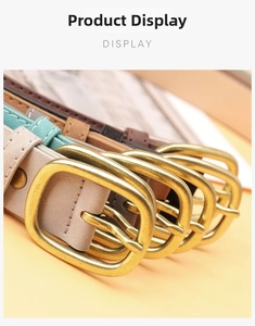 Close-up of suede leather belts with vintage brass oval buckles in assorted colors
