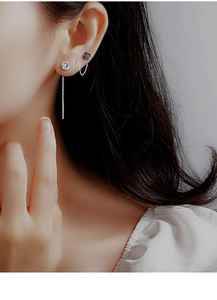 Close-up of S925 sterling silver drop earrings with cz studs and long tassel chains