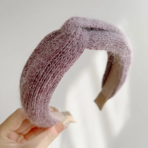 Detail view of the plush knitted texture and twisted knot design on the purple headband