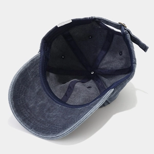 Navy blue washed baseball cap featuring a retro six-panel design and adjustable metal buckle