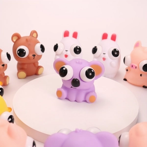 Detail shot of purple koala pop-out eye stress toy with multiple animal squeeze figures