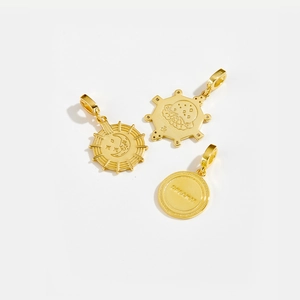 Detailed close-up of S925 sterling silver sun and moon pendants with gold plating