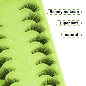 Detailed macro view of 10 pairs natural thick half false eyelashes on green tray