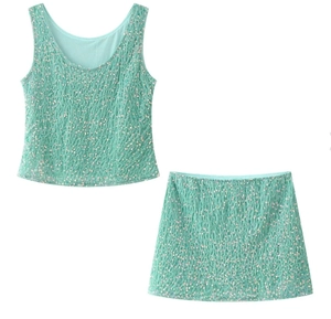 Detail of mint green sequin two-piece set featuring a sleeveless top and mini skirt