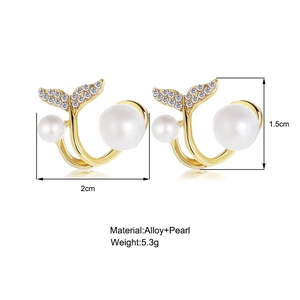 Detail of gold fishtail pearl earrings with 2cm x 1.5cm dimensions and alloy material
