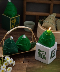 Macro detail of zongzi-shaped scented candle with realistic texture on a wooden background
