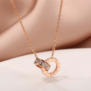 Detail of rose gold interlocking circles necklace with crystals and Roman numerals