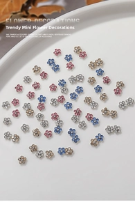 Detailed view of colorful mini 3D metal flower rhinestones for DIY nail art decoration