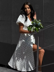 Detail of floral puff sleeves and V-neckline on a white summer maxi cotton dress