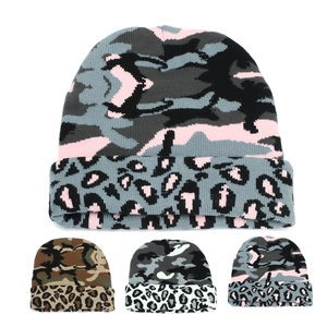 Detail view of camouflage and leopard print knit beanies in multiple color variations