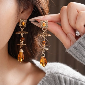 Vintage geometric drop earrings with amber resin stones in antique gold finish