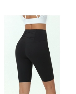 Detail view of high waisted fitness shorts featuring cross-strap design on back waist