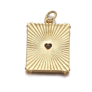 Macro shot of gold rectangle pendant featuring sunburst texture and heart stone center