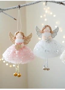 Detail of Christmas angel ornaments with mesh wings, bells and festive plush skirts