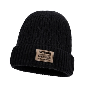 Fleece lined black cable knit beanie for winter warmth with a brown leather fashion patch