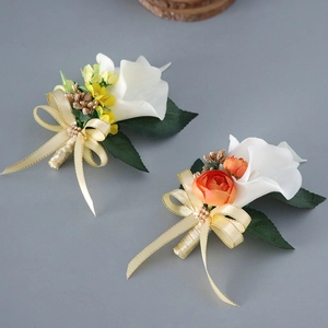 Calla lily wedding boutonnieres with yellow and orange accents and pearl silk ribbons
