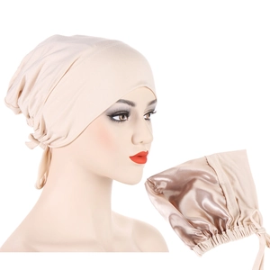 Detail of adjustable beige satin-lined headwear with drawstring and smooth inner fabric