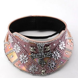 Detailed macro view of punk style visor with pink crystals and metallic skull motifs
