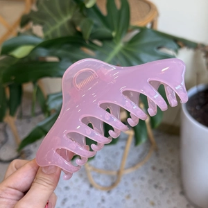 Detail of pink translucent large claw clip with high-quality metal spring for hair