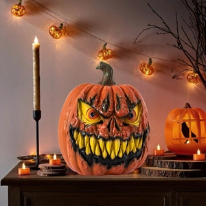 Spooky orange Halloween pumpkin lantern lamp on dark wooden table with candle light