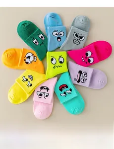Detailed view of ten colorful cotton sports socks featuring embroidered smiley face patterns