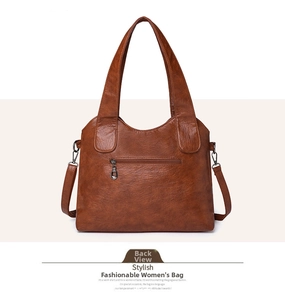 Detailed back view of a brown tote bag featuring a horizontal zipper pocket and hardware